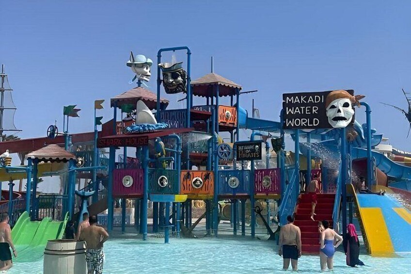 A water park with slides and a sign reading 'Makadi Water World'. 3