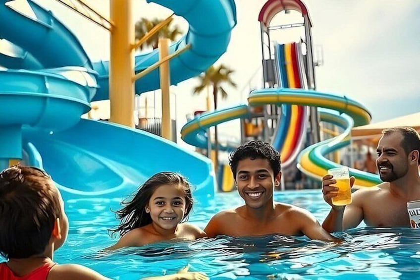A water park with a large blue water slide and a pool area. 1