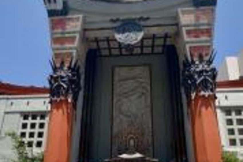 A building entrance with a large door, flanked by two columns with intricate designs. 5