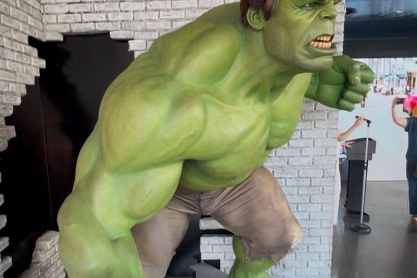 A large Hulk statue in a brick-walled room. 4