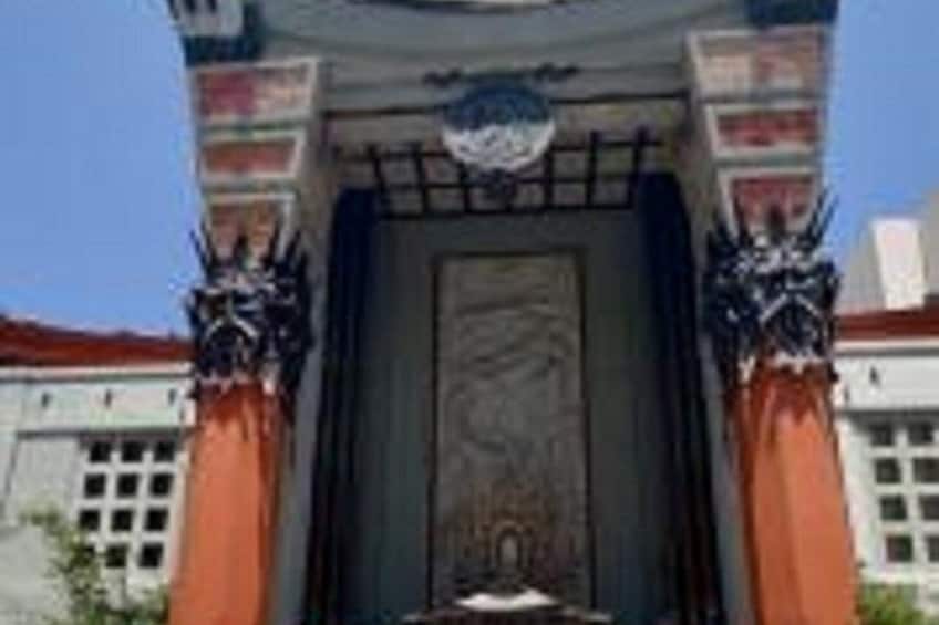 A building with a large, ornate entrance, flanked by two columns with intricate designs. 3