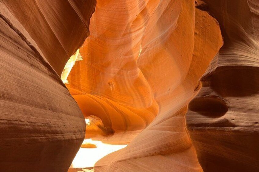 A canyon with smooth, curved sandstone walls and a narrow opening. 1