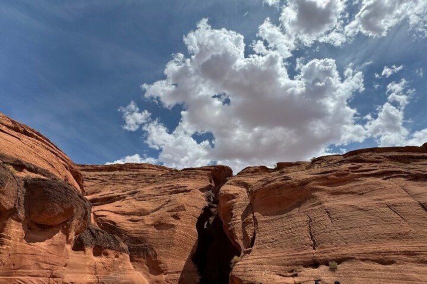 A canyon with layered rock formations and a clear sky. 2