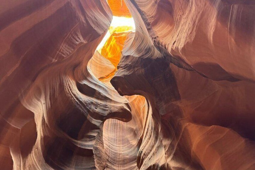 A canyon with smooth, curved rock formations and a narrow passageway. 4