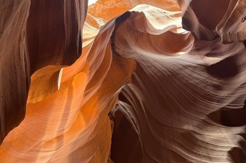 A close-up of smooth, curved sandstone formations. 3