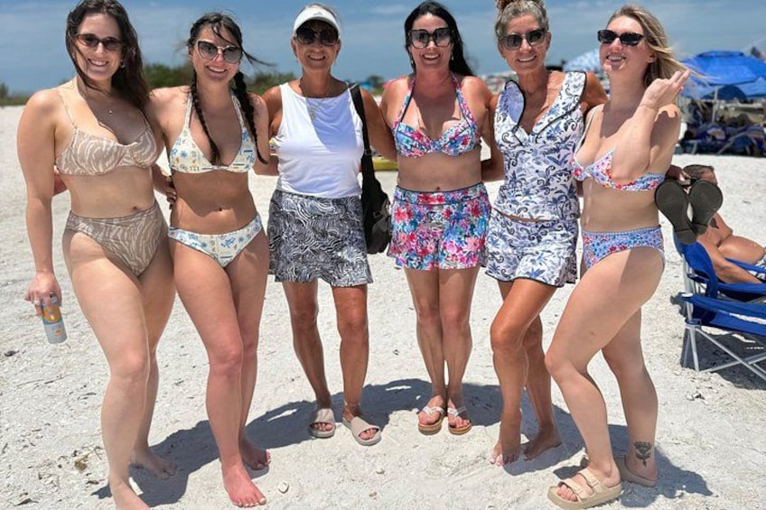 A group of people on a sandy beach. 2