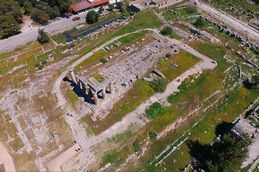 An ancient archaeological site with ruins, pathways, and greenery. 3