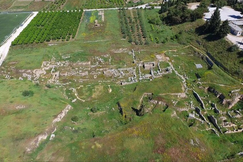An ancient archaeological site with ruins and green fields. 4