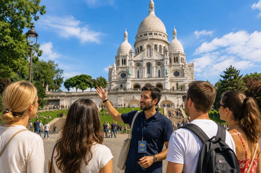 A group of tourists in front of a large, domed building with multiple arches and statues. 1