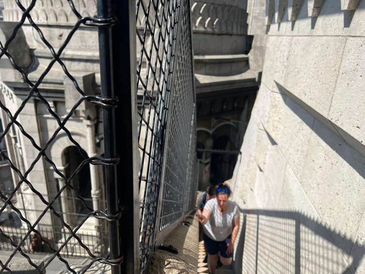 A chain-link fence with a person climbing over it. 4
