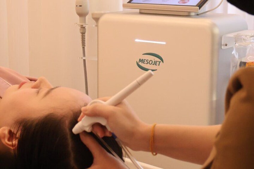 A dental procedure with a patient lying down and a dental professional using a device on the patient's head. 3