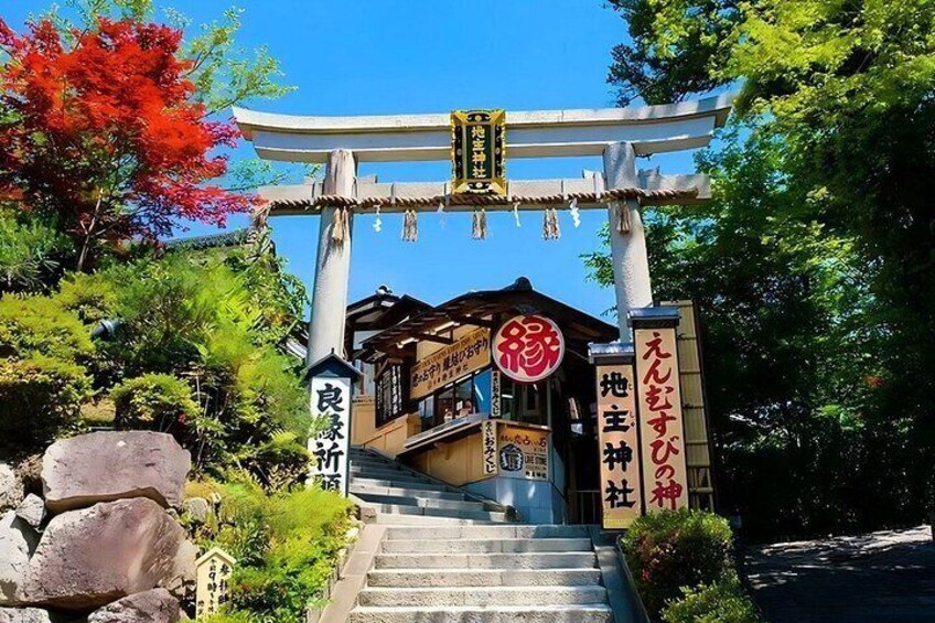 A traditional Japanese torii gate, a wooden staircase, and a building with Japanese signage. 5