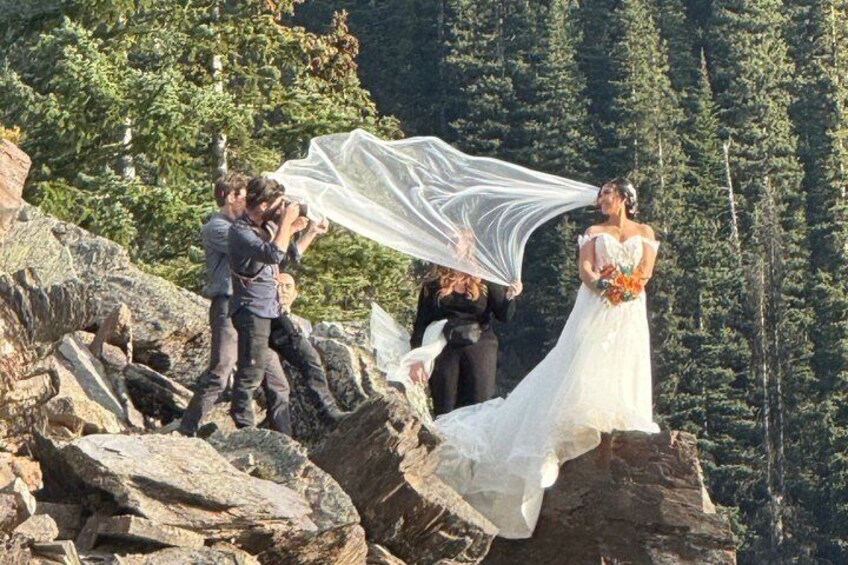 A wedding ceremony on a rocky mountain with a forest in the background. 3