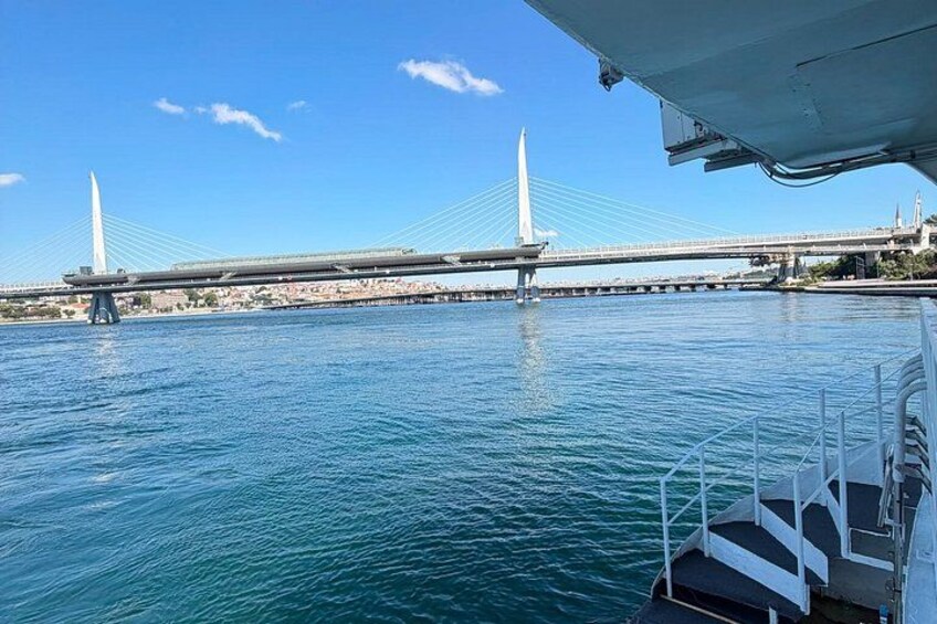 A bridge over water with a boat in the foreground. 3
