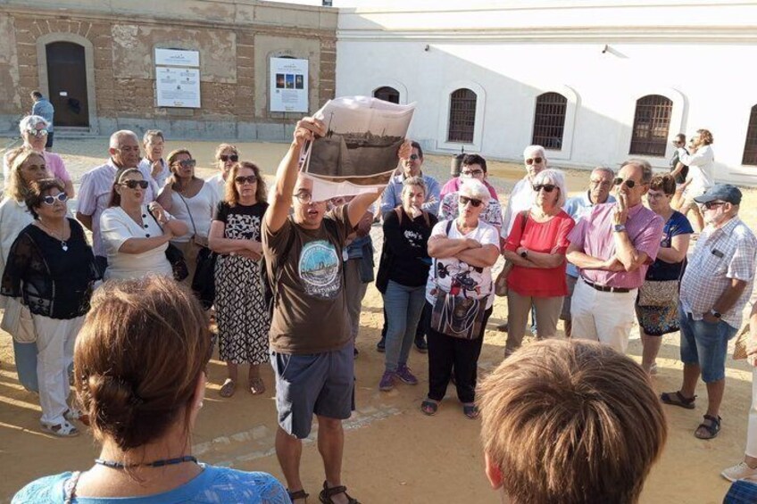 A group of people outdoors, some holding a large object above their heads. 5