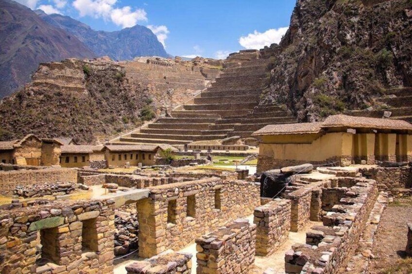 Ancient stone structures, terraced steps, and a mountainous backdrop. 5