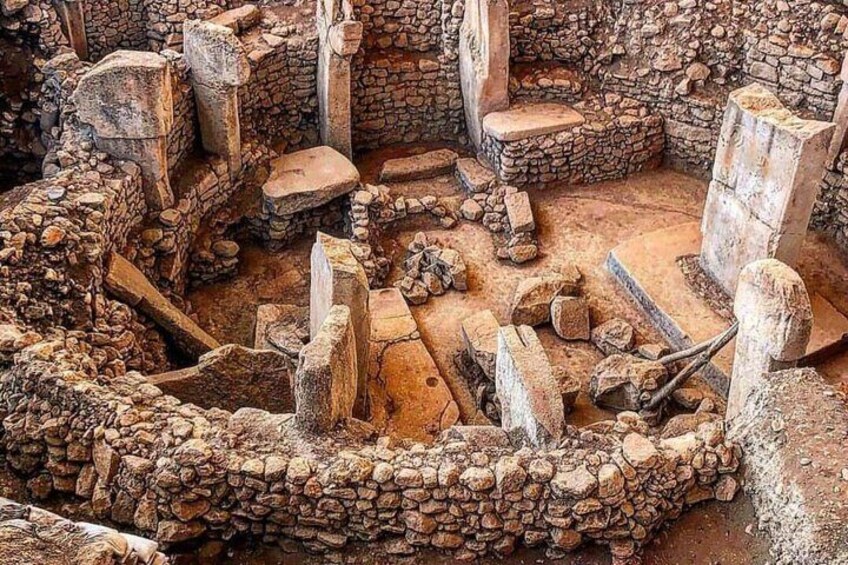 Ancient stone ruins with circular stone structures and scattered stone blocks. 3