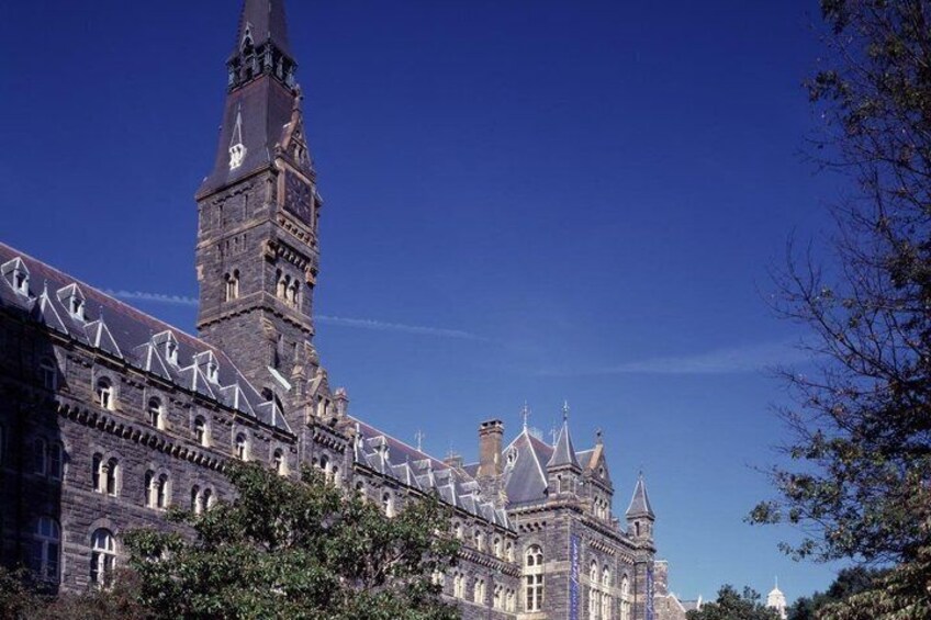A historic building with a prominent clock tower and spires. 4
