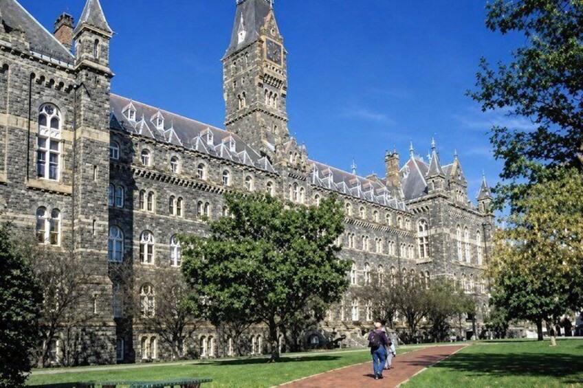 A historic stone building with multiple towers and arched windows. 2