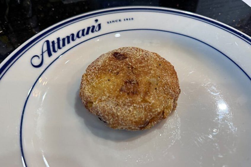 A single glazed donut on a plate with a blue rim and the text 'Autman's' on it. 5