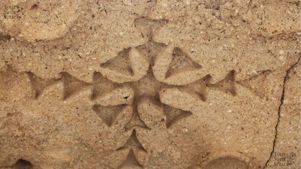 A close-up of a rock surface with carved patterns. 4