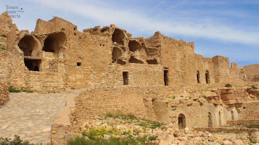 Ancient ruins with stone walls and arched doorways. 1