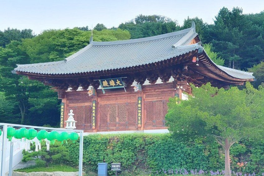 A traditional Korean temple with a tiled roof and ornate wooden architecture. 2
