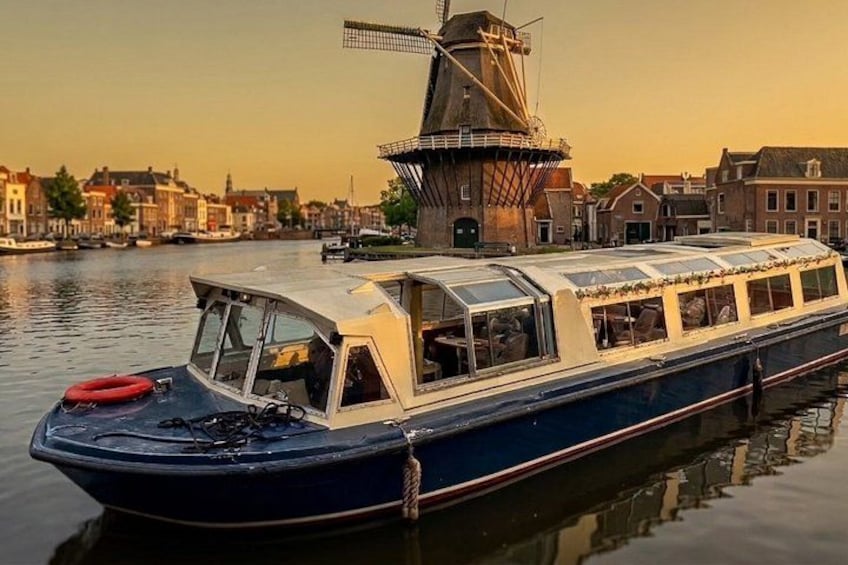 A boat with a windmill in the background. 1