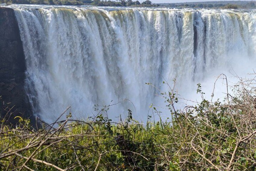 A large waterfall with multiple streams of water cascading down a rocky cliff. 2