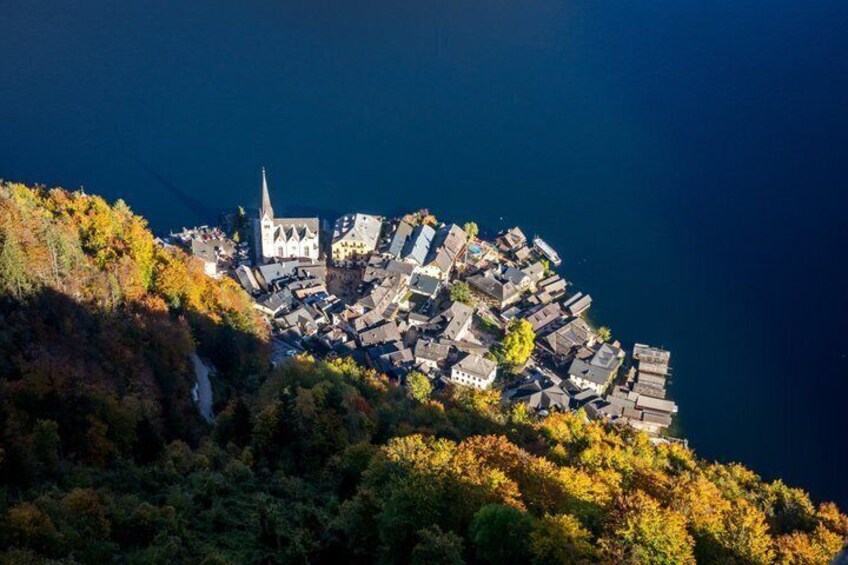 A coastal town with a prominent church and dense housing clustered on a hillside. 3