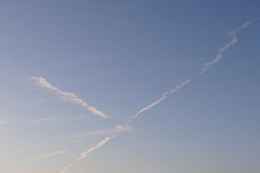 A clear sky with two visible contrails. 2
