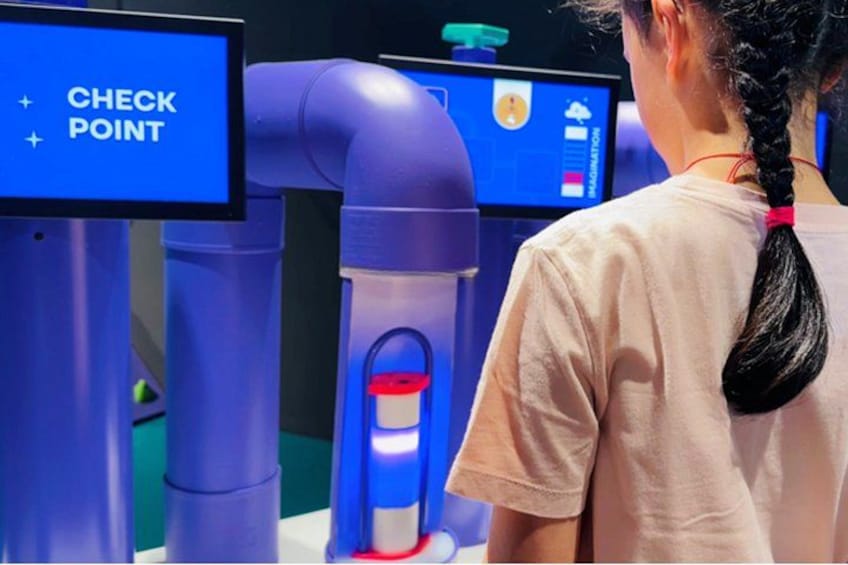 A person interacting with a robotic arm and a screen displaying 'CHECK POINT'. 3