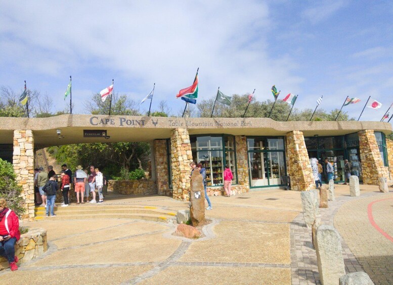 The entrance to Cape Point, Table Mountain National Park, with stone pillars and flags. 5