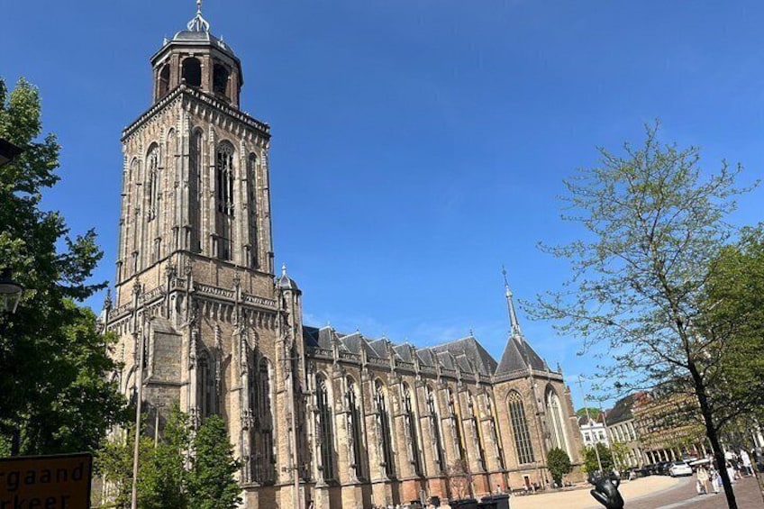 A historic church with a tall bell tower and a spire. 3