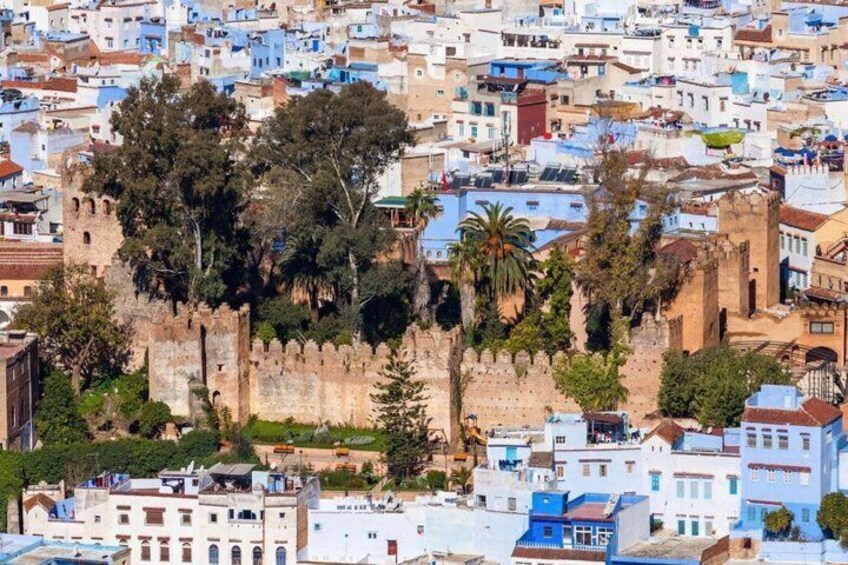 A densely packed urban area with a prominent historical fortification surrounded by residential buildings. 2