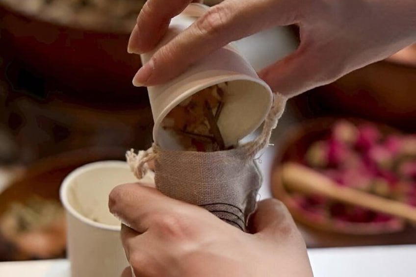 A person pouring a liquid from a container into a cup. 3
