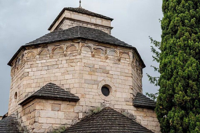 A stone tower with a rounded top and a small circular window. 2