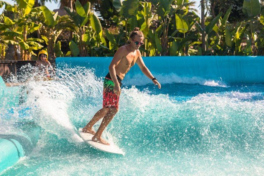 A person surfing in a pool with waves. 3