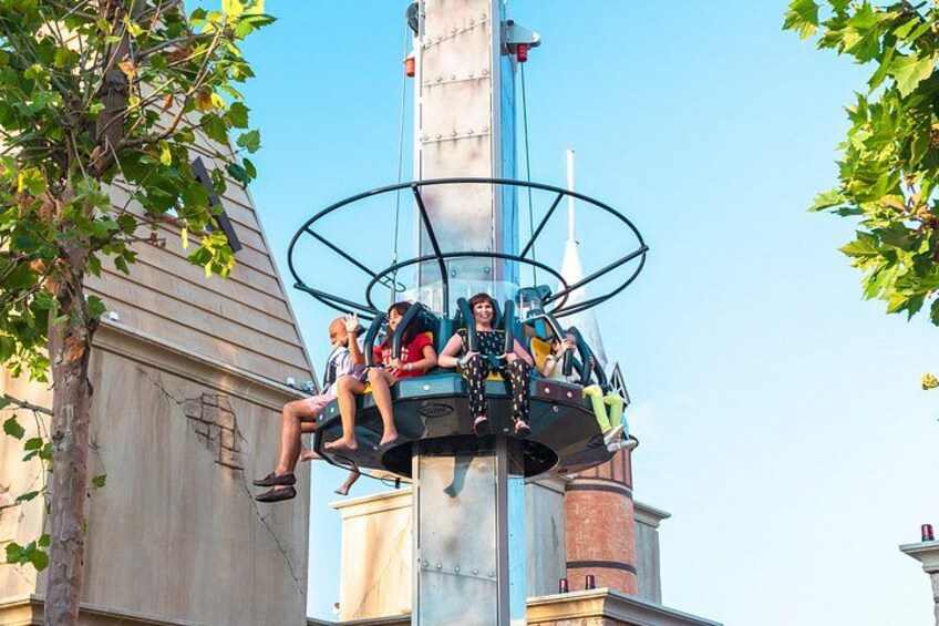 A ride with passengers seated in a circular structure. 2