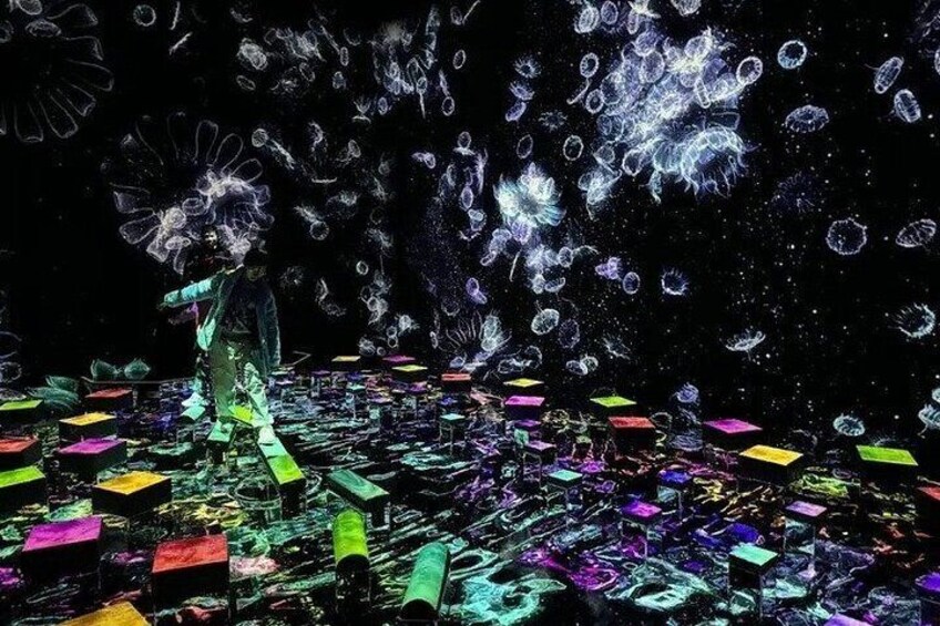 A person standing amidst floating colorful blocks and bubbles in a dark environment. 2