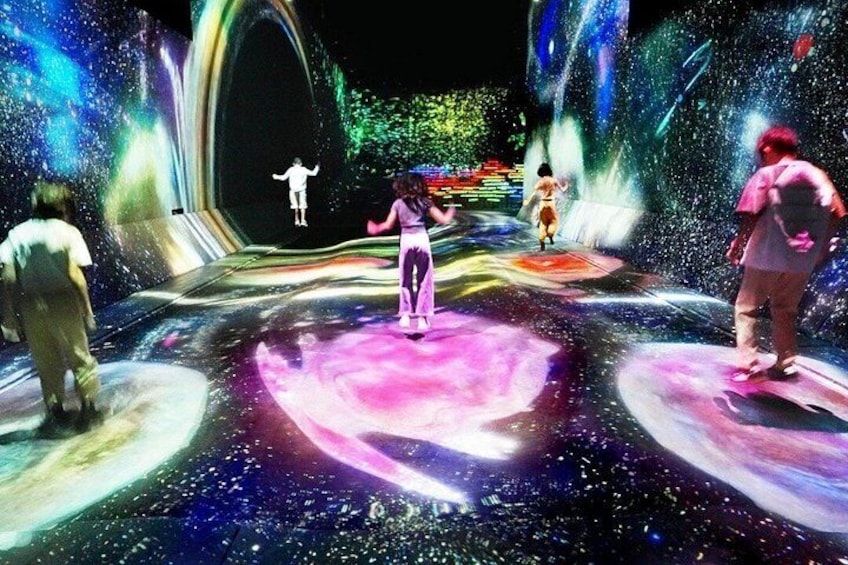 A space-themed stage with performers and a large circular platform. 3