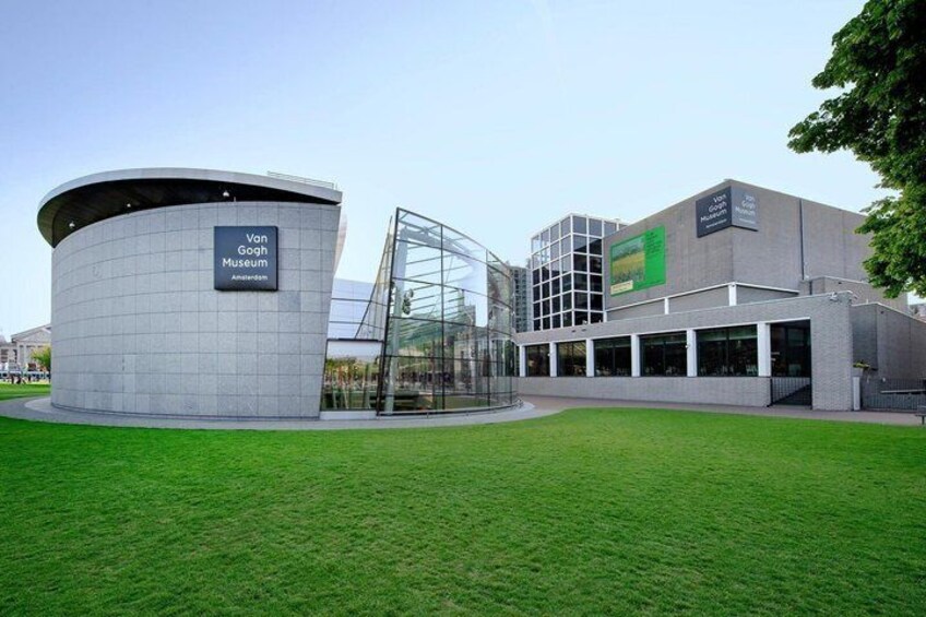 The Van Gogh Museum in Amsterdam, featuring a modern building with a circular structure and a glass facade. 3