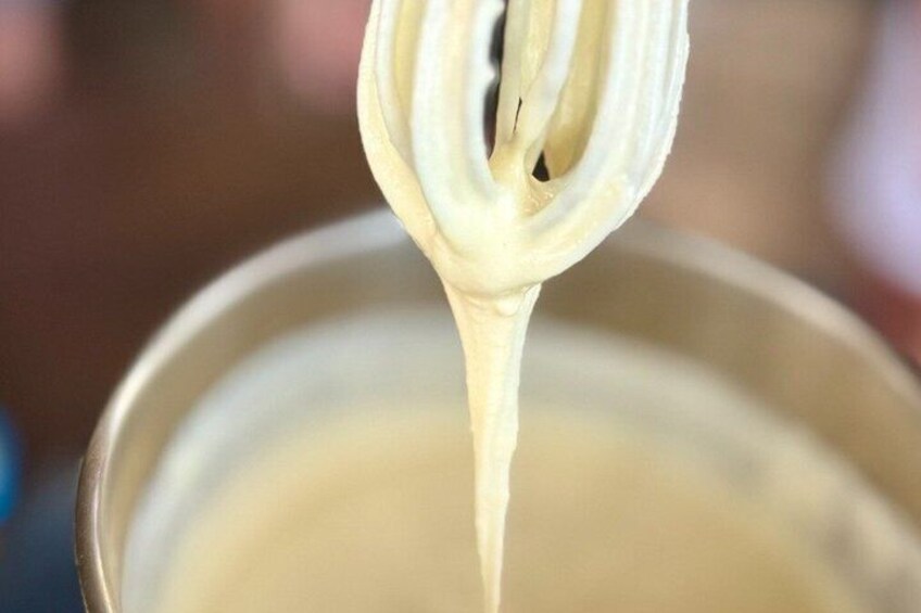 A close-up of a liquid being strained through a sieve. 3