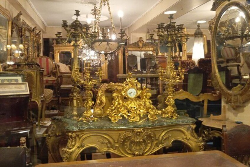 An antique shop with ornate furniture and mirrors. 2
