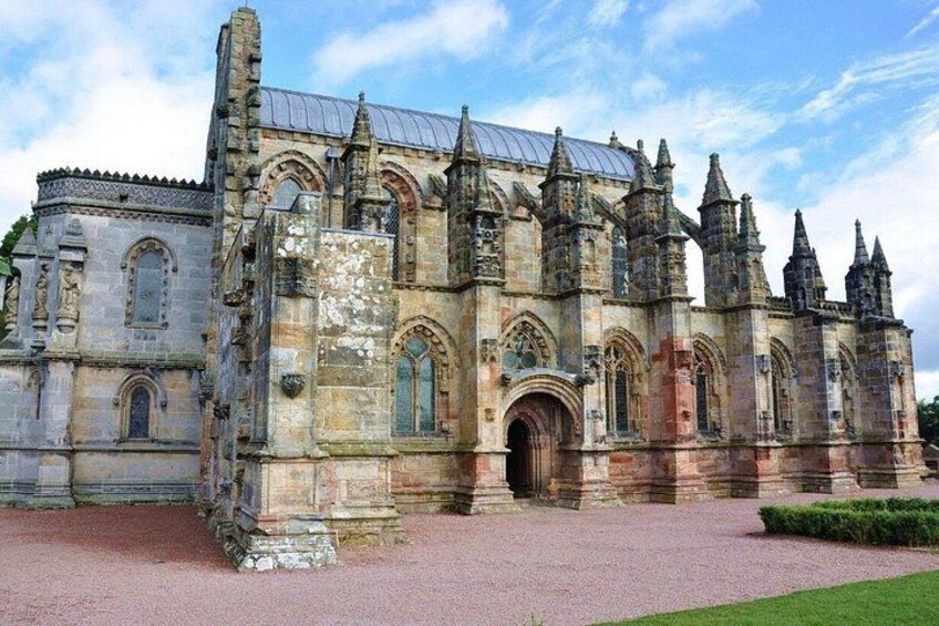 A historic stone building with multiple spires and arched windows. 1