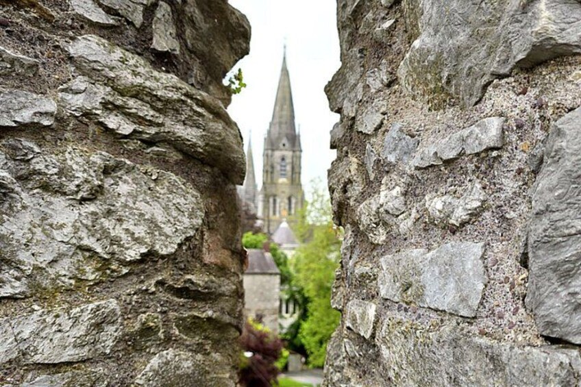 A stone archway with a church in the background. 3