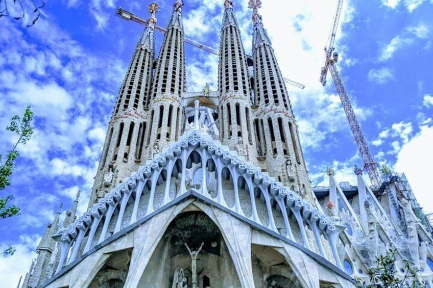 A cathedral with three spires, intricate stone carvings, and a large arched entrance. 2