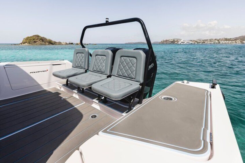 A boat with two cushioned seats and a sunshade on the deck. 5