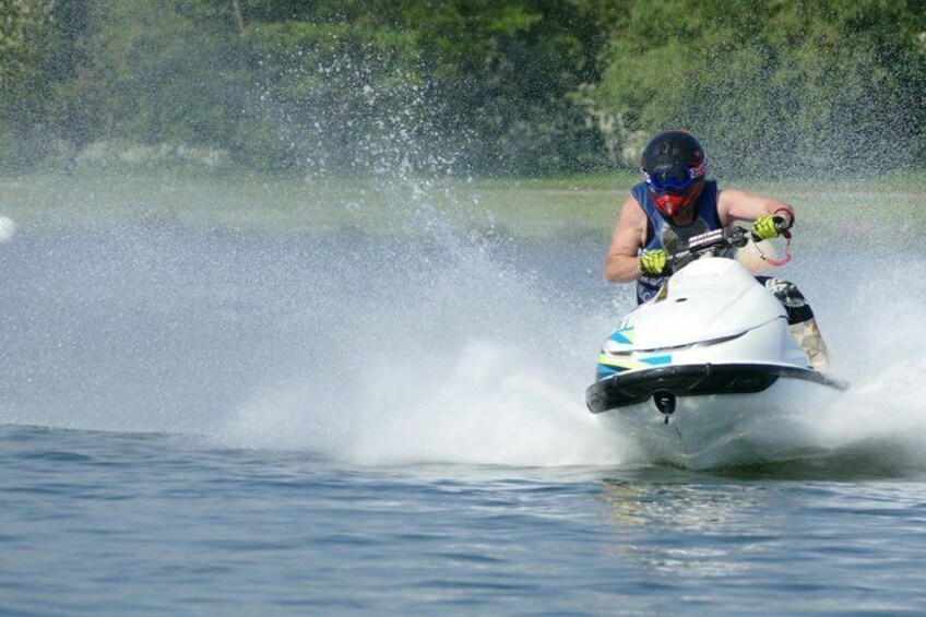 A person riding a jet ski on water. 1