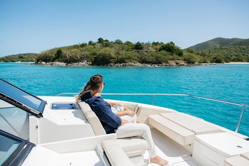 A person on a boat with a view of a coastline and hills. 3